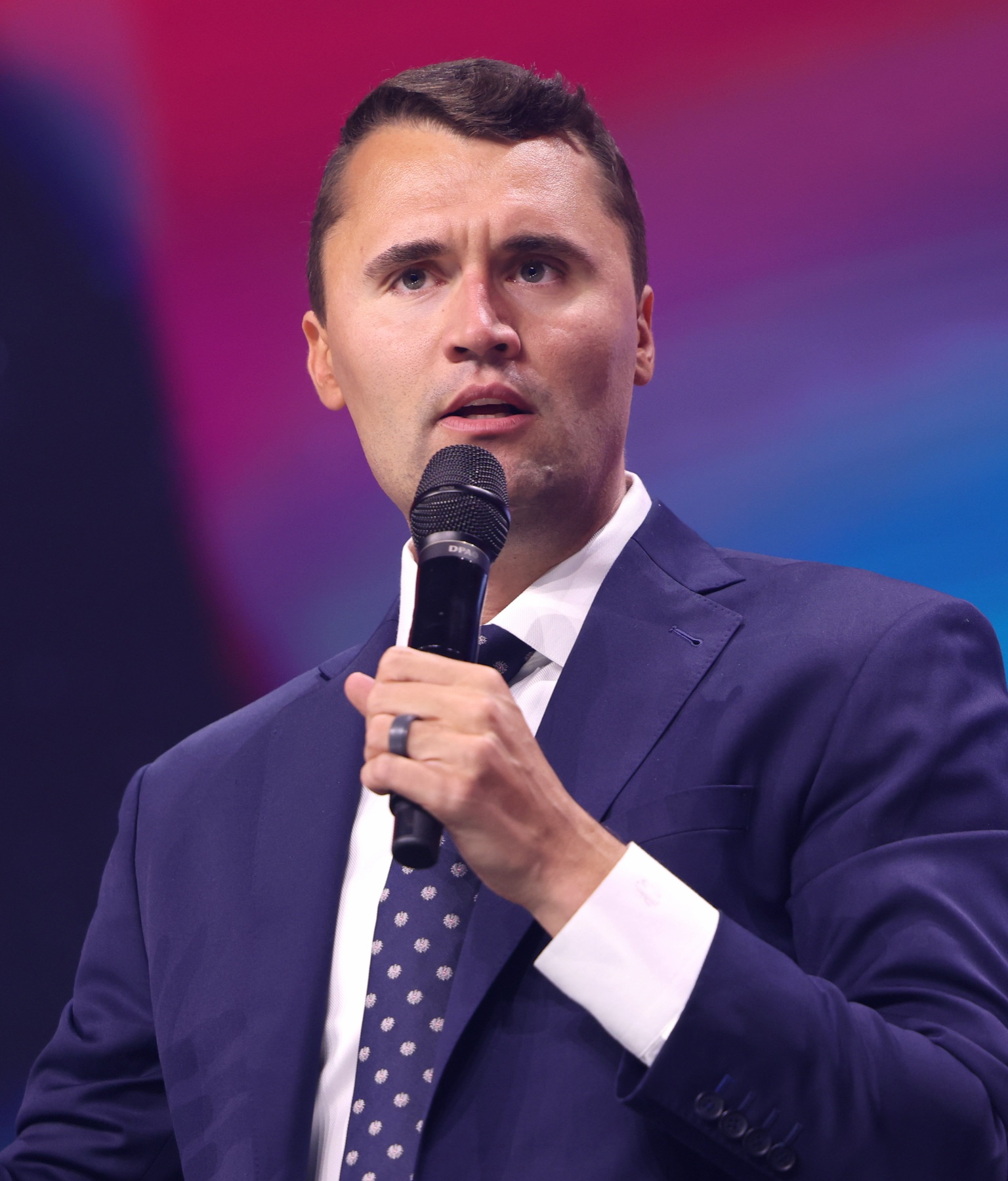 Charlie Kirk with microphone at a public event